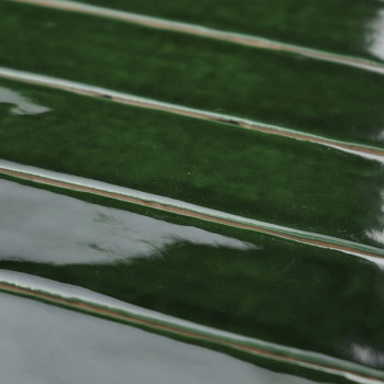 Green ceramic tiles with a glossy finish appear horizontally arranged, reflecting light in a closely spaced, overlapping pattern