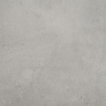 Un azulejo gris claro de textura suave reposa plano, mostrando leves moteados y sutiles variaciones de tono, lo que sugiere un a