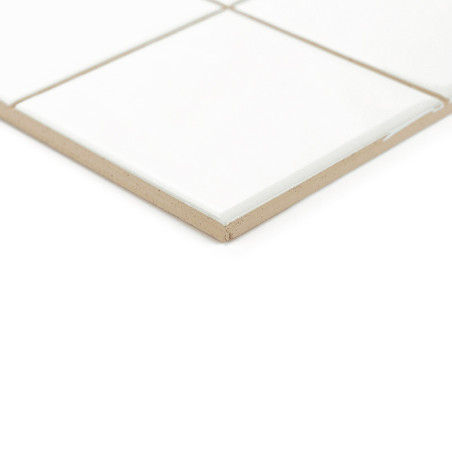 Un carreau de céramique à la surface blanche brillante repose sur une base beige, faisant partie d'une grille dans un décor mini