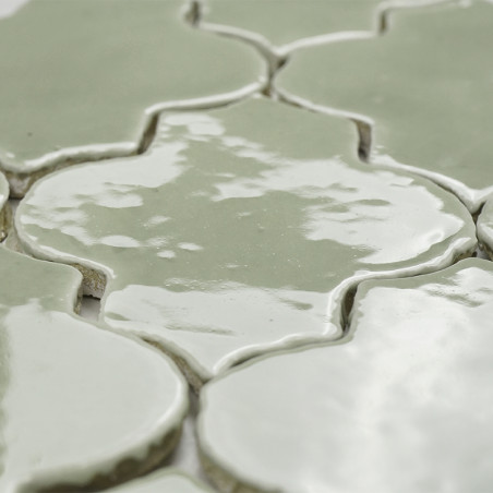 Glazed terracotta tiles display a wavy pattern with a glossy finish, interconnected seamlessly creating a cohesive, elegant surf