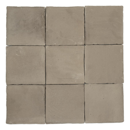 Nine square terracotta tiles arranged in a three-by-three grid, displaying a rustic, natural finish against a blank background.