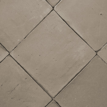 Terracotta tiles arranged diagonally, creating a diamond pattern on a flat, neutral-colored floor surface.