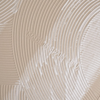 A beige tile features embossed concentric circular ridges, creating a textured pattern. Text reads `MADE IN SPAIN EU` within the