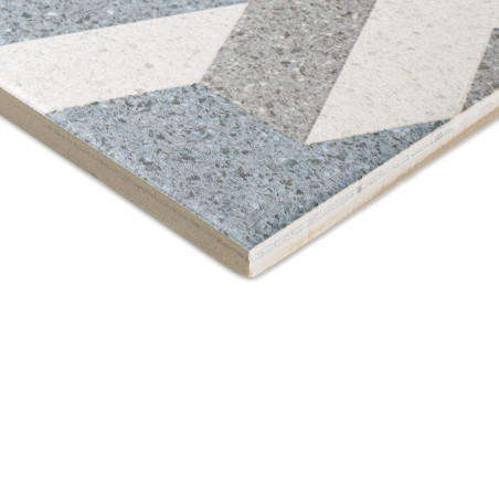 Azulejo cerâmico com padrões geométricos com seções cinza, branca e azul. a borda angular do ladrilho revela uma estrutura em ca