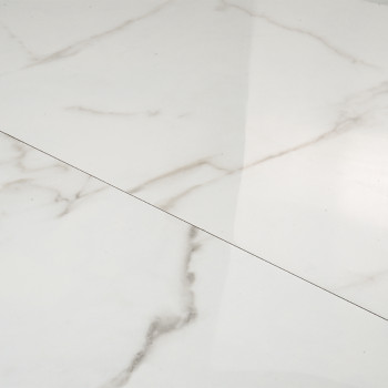 White marble tile with subtle gray veining creates a smooth, polished surface, reflecting light in a minimalist interior setting