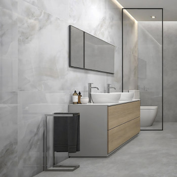 Un meuble-lavabo avec double vasque et meuble en bois se dresse contre un mur de marbre, sous un long miroir dans un cadre minim