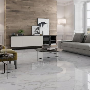 Glossy white marble tiles cover the floor, reflecting light in a modern living room with a gray sofa and wooden accents.
