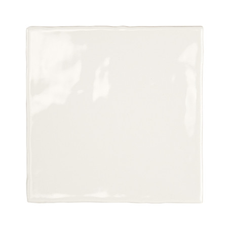 Un azulejo de cerámica brillante de color blanquecino se encuentra centrado, reflejando la luz y con bordes limpios. Se apoya so