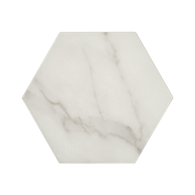 Hexagonal marble tile with soft gray veining, resting against a white background, evoking a clean and modern aesthetic.