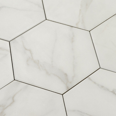Hexagonal marble tiles form an interlocking pattern with subtle gray veining, creating an elegant, continuous surface in a moder